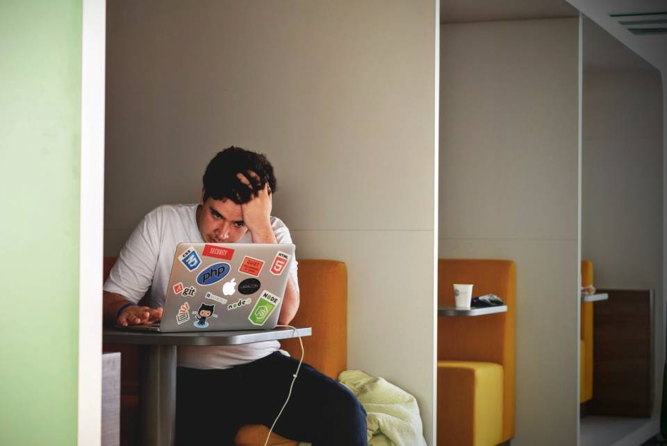 Kein Bock auf Arbeit - Mann sitzt frustriert vor Laptop